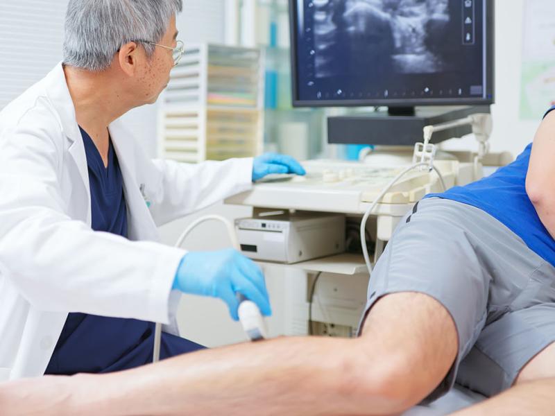 A physician using a machine to examine a patient.